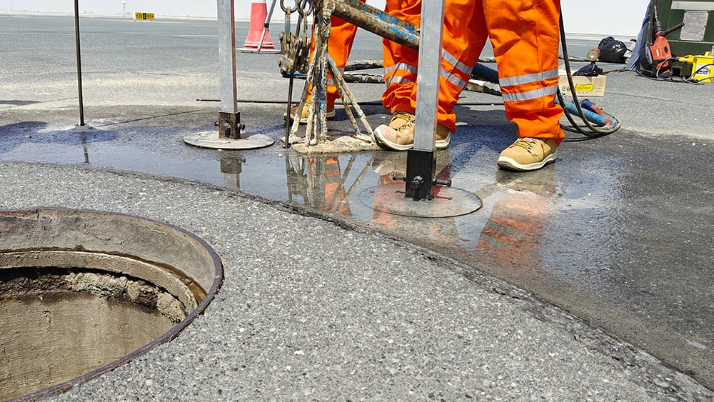 Close up of manhole lifting work at airport with Geobear techs