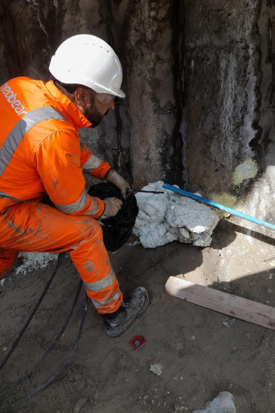 Site operative carrying out localised water-sealing treatment at the shoring wall, Geobear's water seepage solution