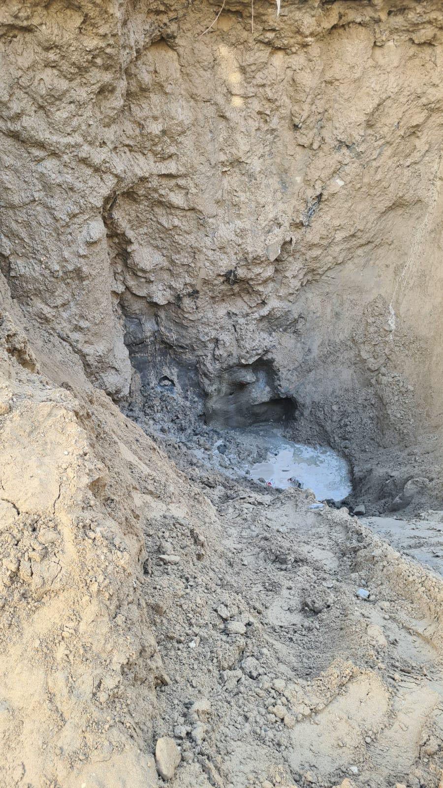 Localized erosion / cavity formation associated with persistent seepage.