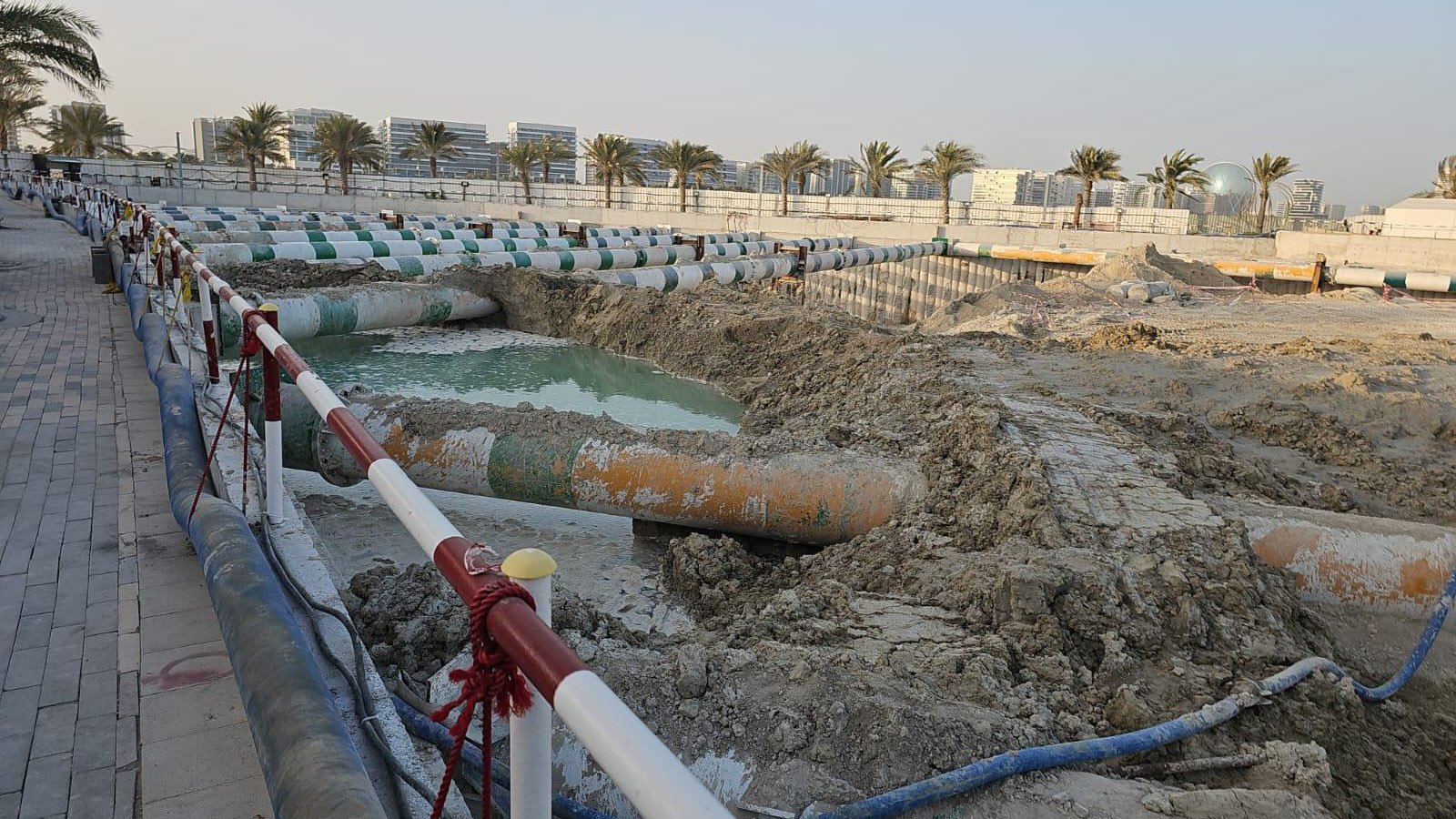 Deep braced excavation with visible water accumulation and internal strutting