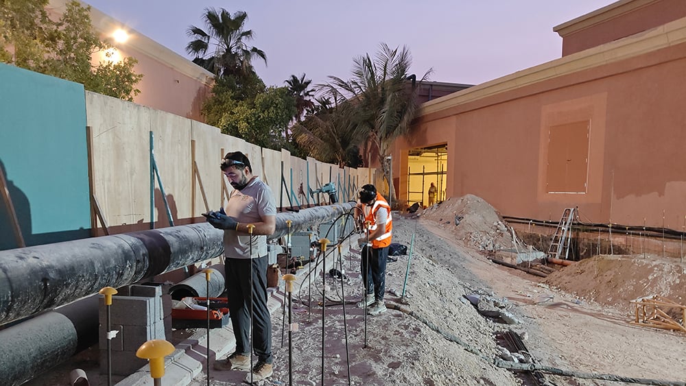 Geobear techs injecting geopolymer in side of building foundation