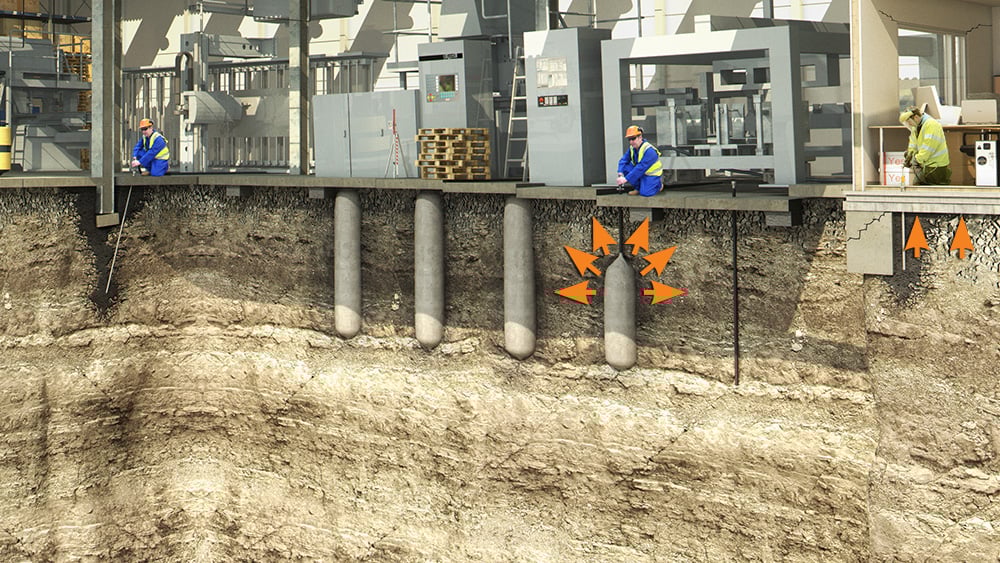 Illustration showing the installation of powerpiles in the ground beneath a commercial building, viewing a cross section