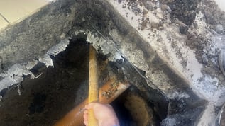 View into void where soil has collapsed in public utility opening