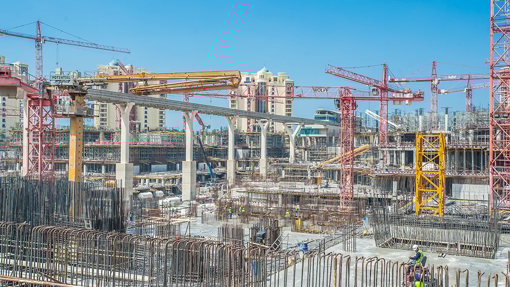 UAE construction site showing cranes rebar and workers