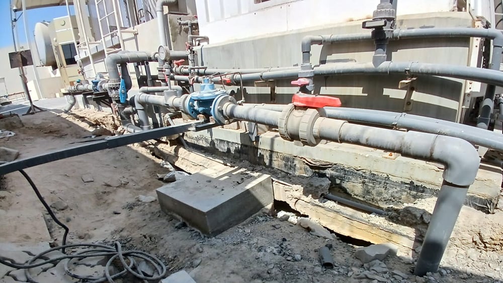 view of gas pipes coming from beneath the soil.