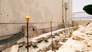 UAE side of villa with brickwork removed and injection tubes inserted into the soil.