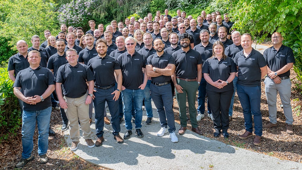 Geobear employees standing for a group photo on a sunny day