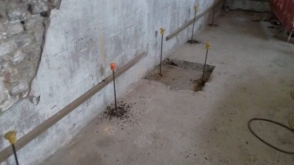 Interior view of drilled injection points with tubes inserted and safety caps