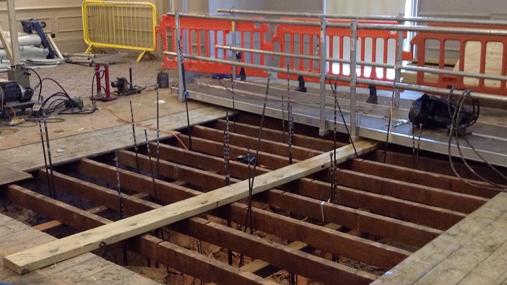 Queens Hotel Cheltenham interior work area view of exposed floor joists above a sinkhole void.