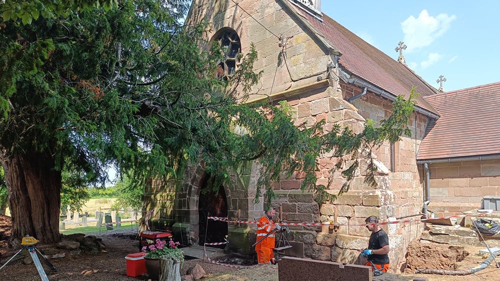 Exterior view of St. Mary's church with Geobear techs working at front foundation