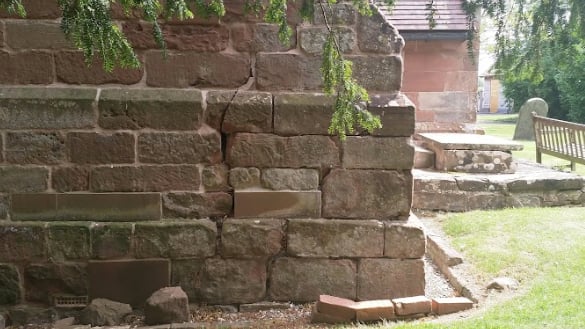 Corner of St. Mary's Church at ground level with subsidence cracks visible between large brickwork