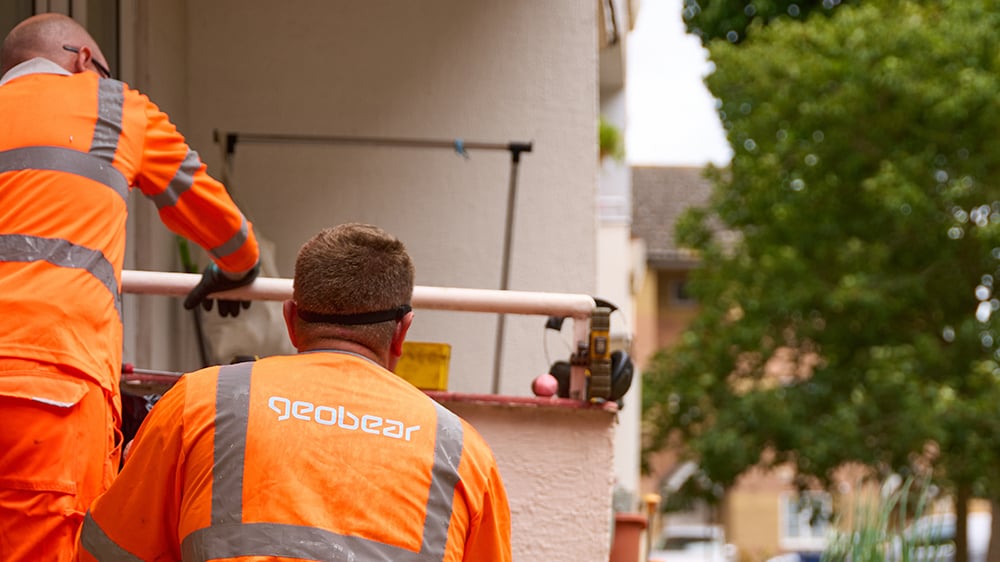 Two Geobear techs monitoring injection on a terrace which is sinking.