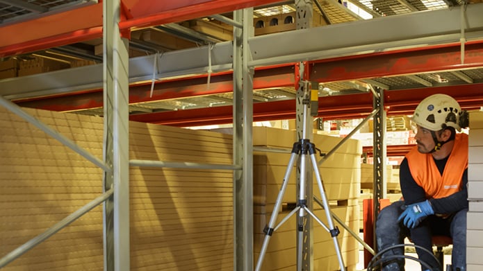 Geobear tech operating under in-place warehouse racking system