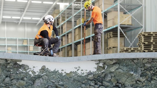 Illustration depicting geopolymer injected under a concrete slab into soil (binding the soil) in a retail backroom.