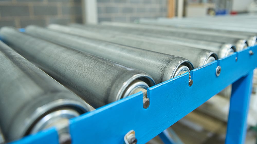 Close up view of rollers on a roller conveyor