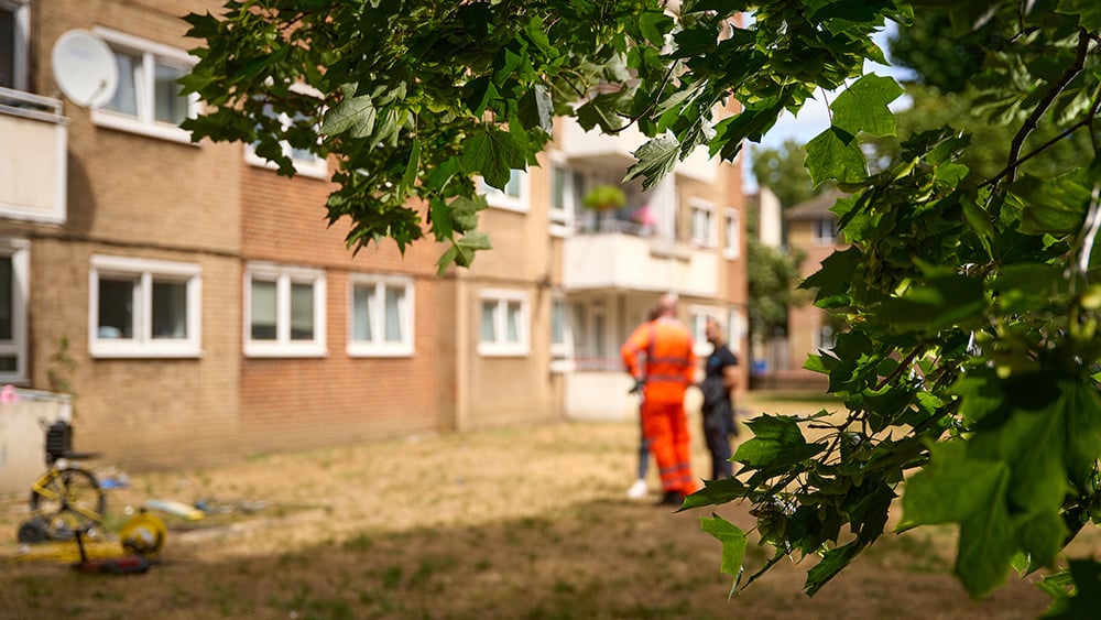 View of Geobear techs in front of a residential block of flats in London.