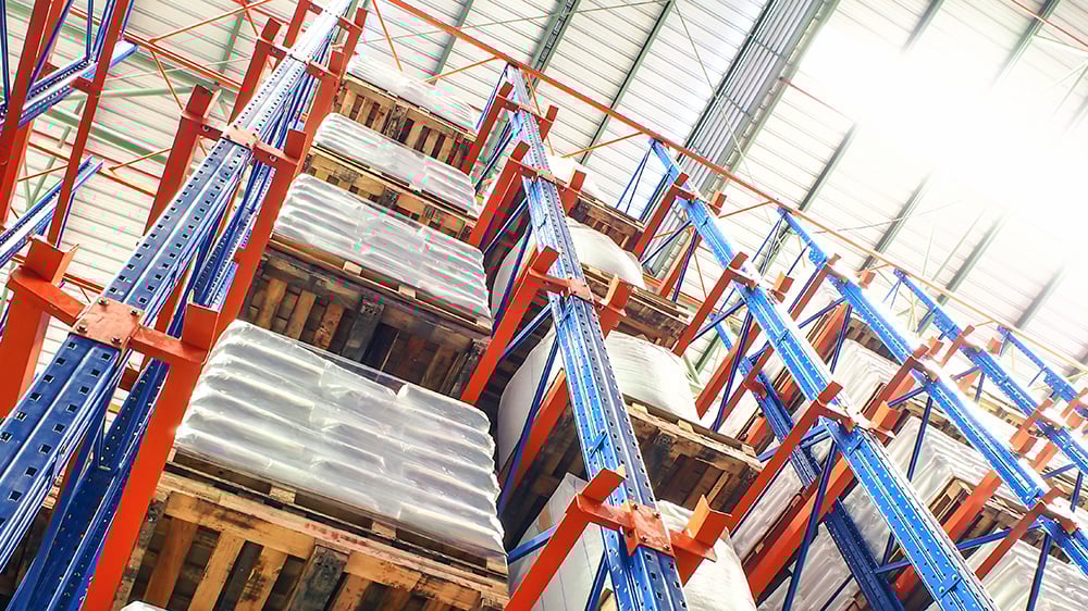 View of warehouse shelving looking from ground upwards to the high top