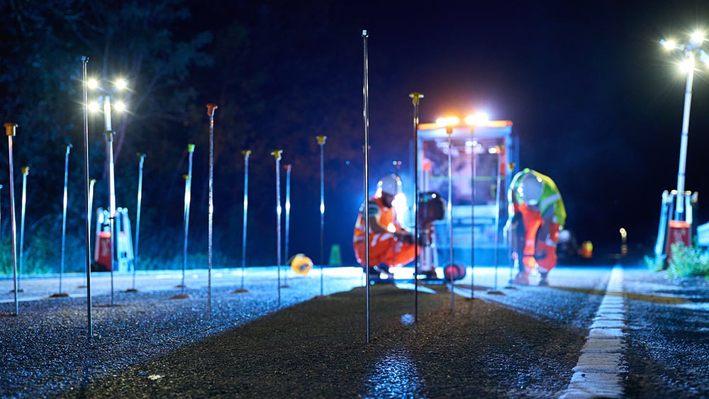 Geobear drilling team at work on motorway pavement at night