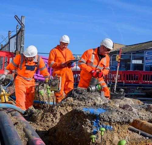 Three Geobear techs at a construction site in a rail yard