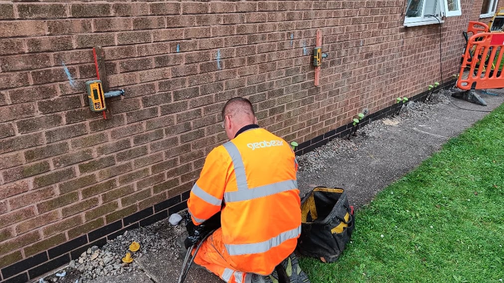Geobear tech working with injection points on side of a brick wall