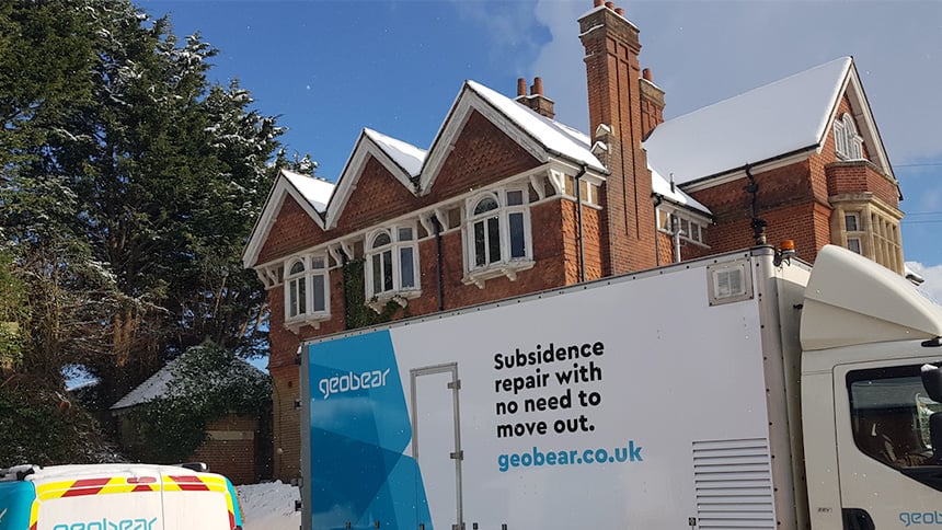 Geobear truck in front of a brick victorian home