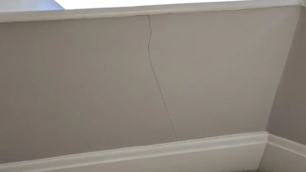 A hairline crack in an internal home wall