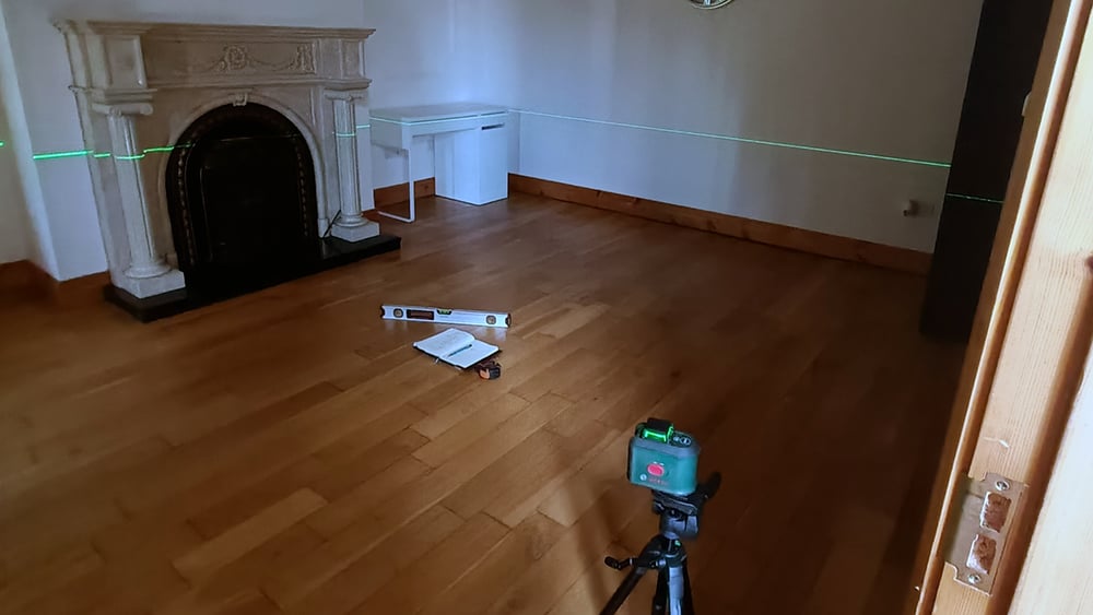 view of laser level inspection inside a residential home as part of a Geobear foundation inspection