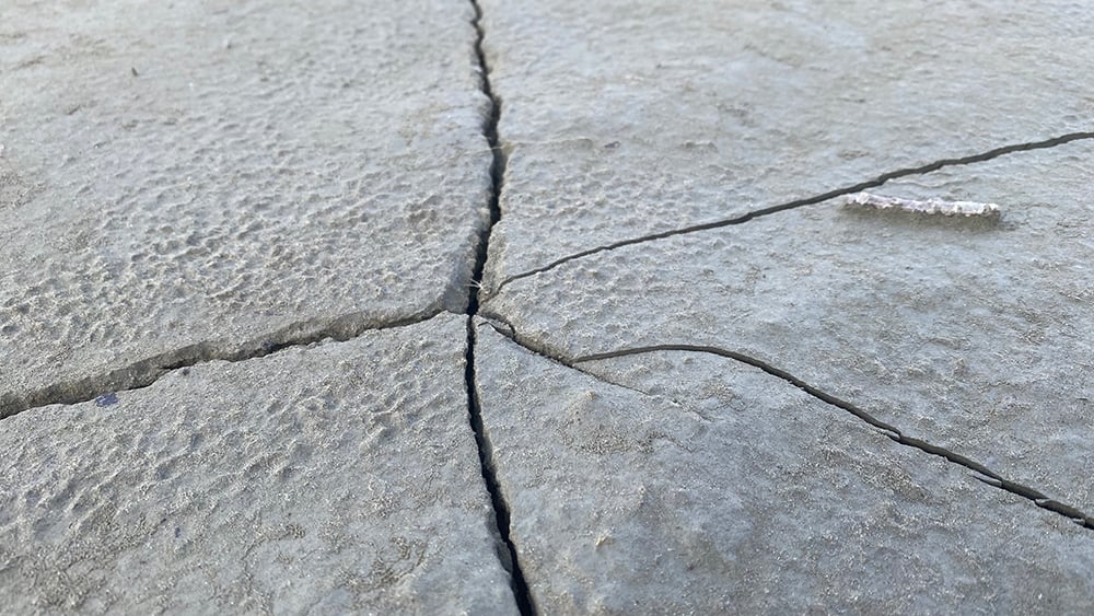 Close up view of cracked concrete patio floor