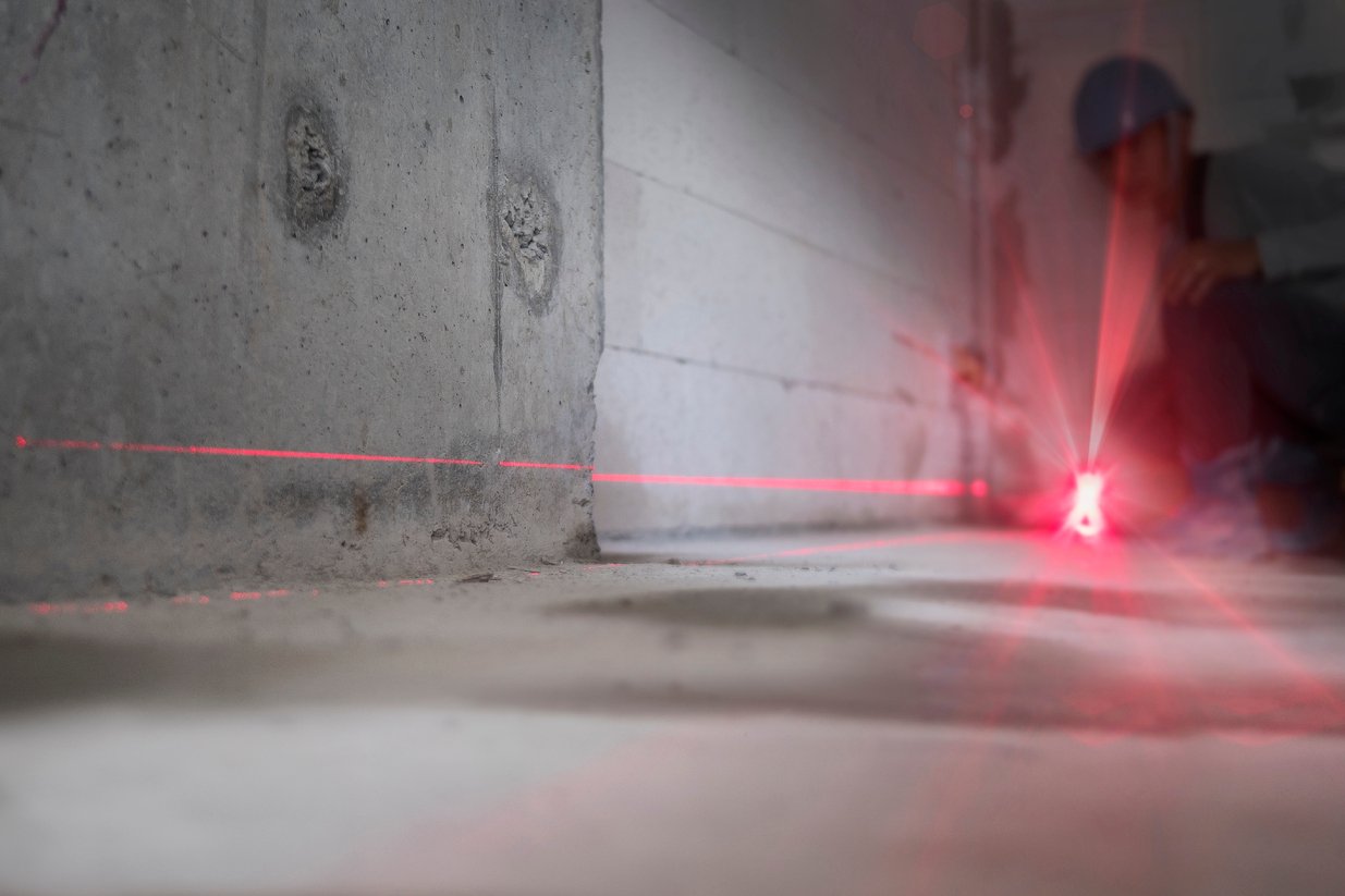 A laser level on a foundation floor to check for unlevel floors